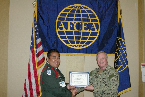 Capt. Gerry Slevin, USN, chapter president, presents a STEM Scholarship certificate to a student recipient in April.